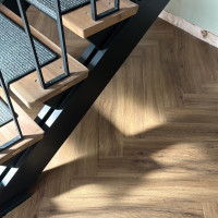 metal staircase and herringbone wood floor